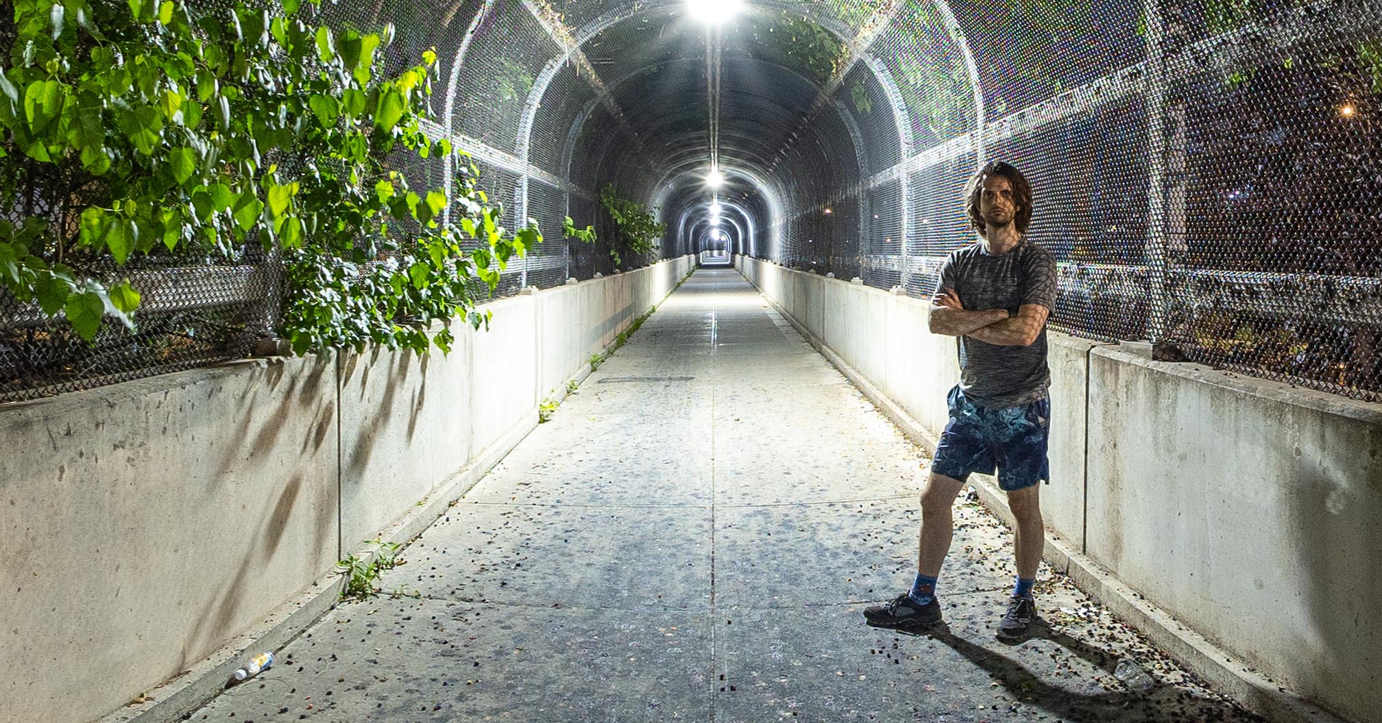 Zach standing at the base of a steep walking/biking path leading up to the RFK Bridge in NYC.